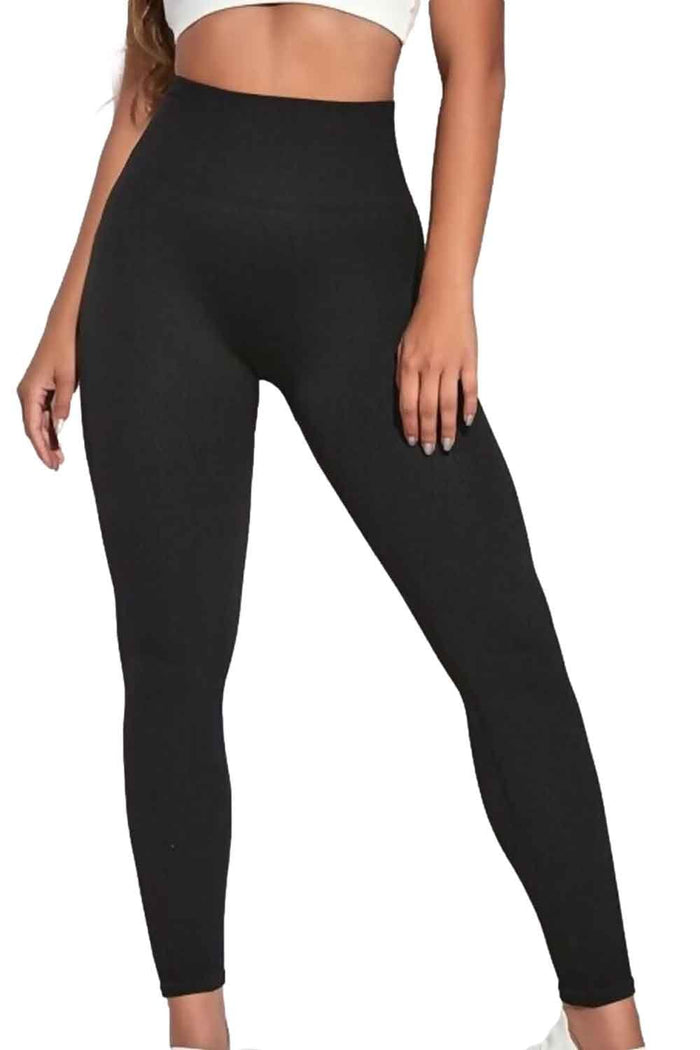 Black  ribbed leggings worn by a model on a white background