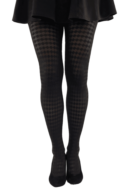 Black  jester checkered tights worn with a black skirt on a white background