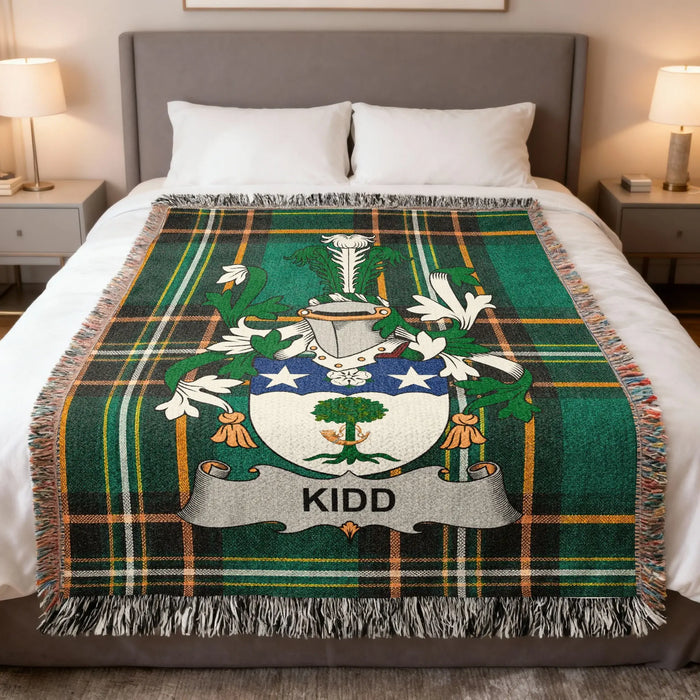 Kidd Irish family crest woven blanket displayed on a bed.