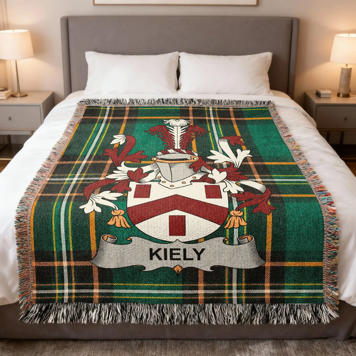 Kiely Irish family crest woven blanket displayed on a bed.