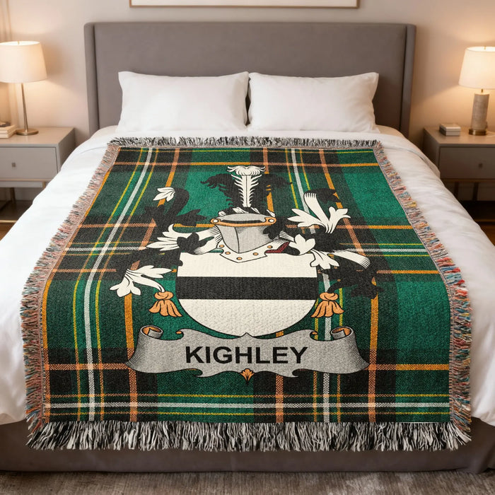 Plaid blanket with Kighley family crest draped on a bed.