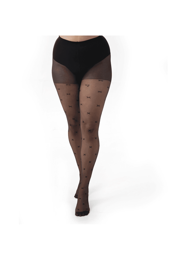 Black patterned sheer kiss tights worn by a person on a white background
