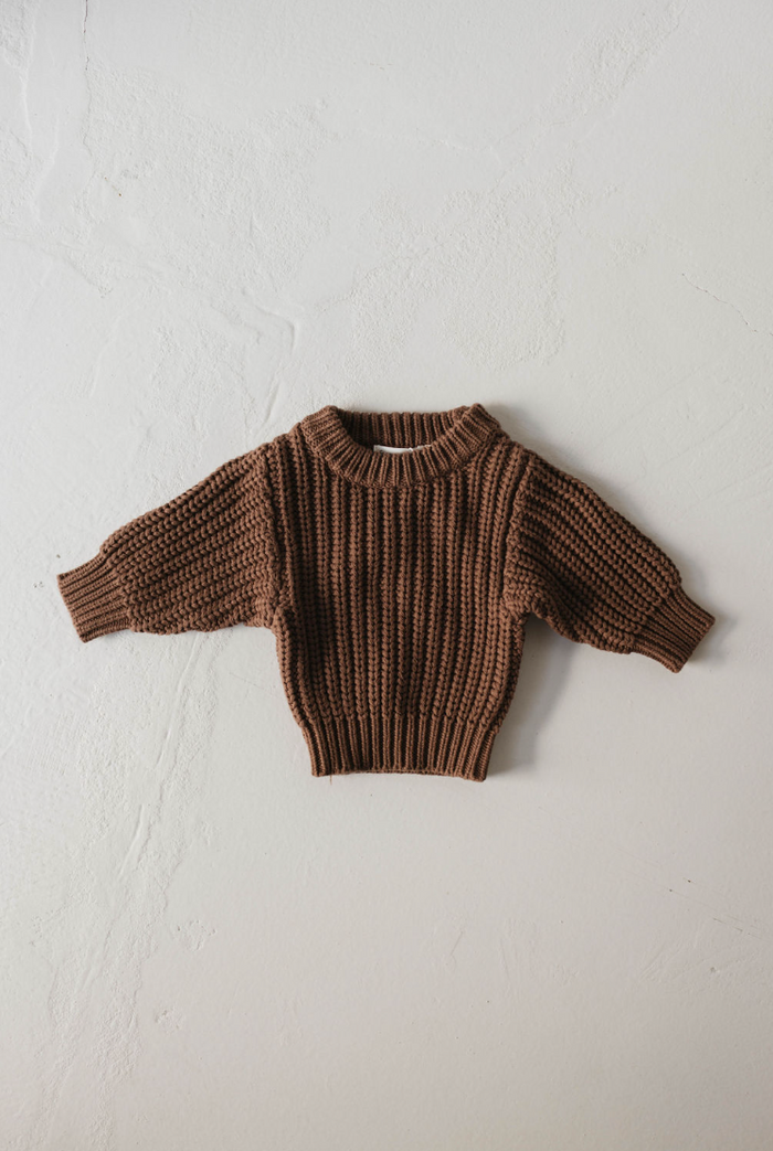 The Hot Cocoa | Knit Sweater by forever french baby is a brown, long-sleeved knit with ribbed neckline, cuffs, and hem—perfect for keeping your little one cozy and warm.