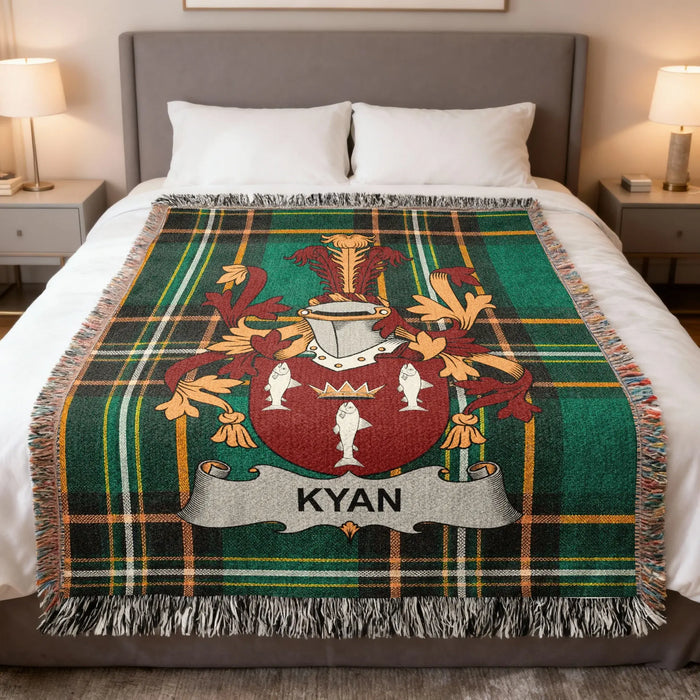 Kyan Irish family crest woven blanket displayed on a bed.