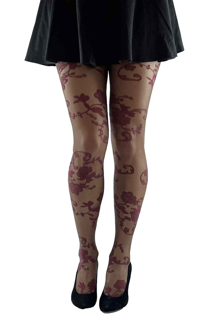 Floral  lace patterned tights worn with a black skirt on a white background