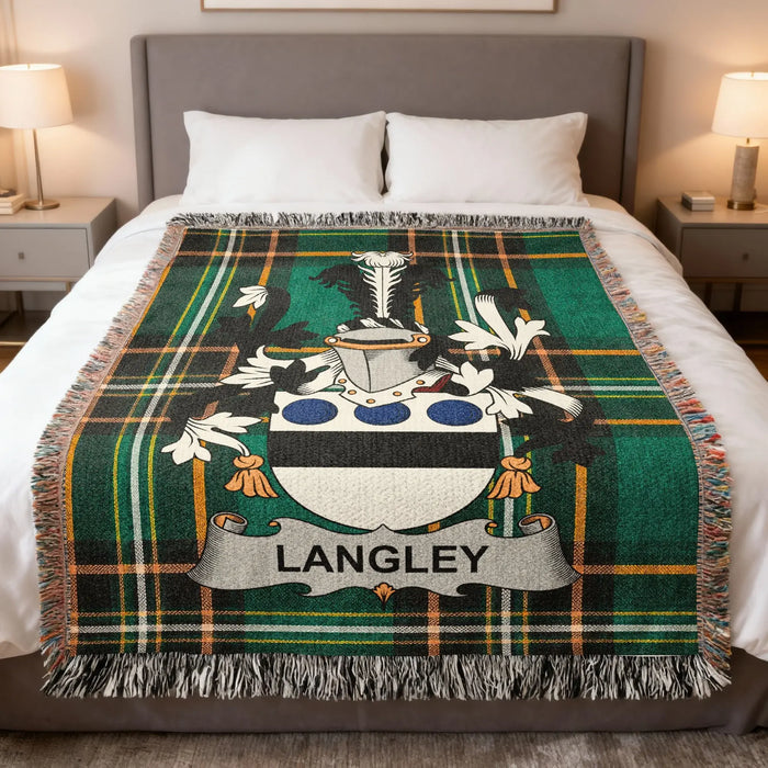 Langley family crest woven blanket arranged on a made bed.