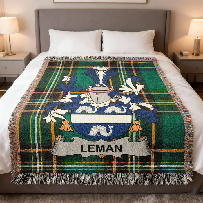 Leman family crest woven blanket folded across a bed.