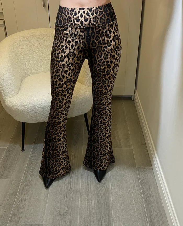 Flared leggings  with leopard design throughout by Allana, standing in front of a chair