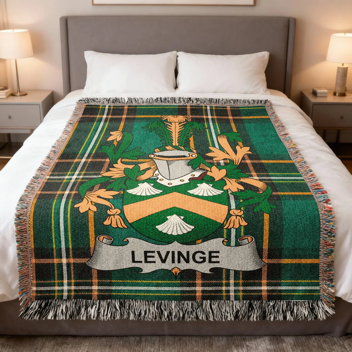 Levinge family crest woven blanket laid across a bed.