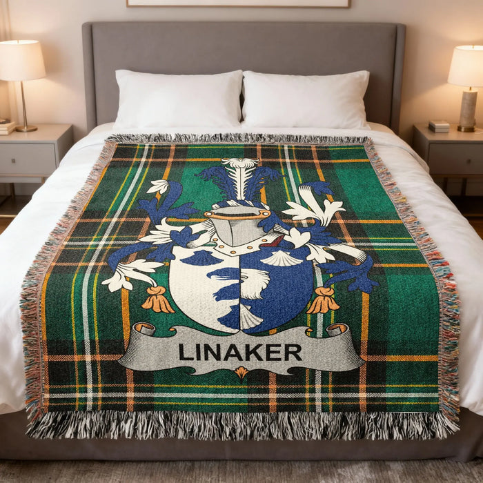 Linaker family crest woven blanket spread on a bed.