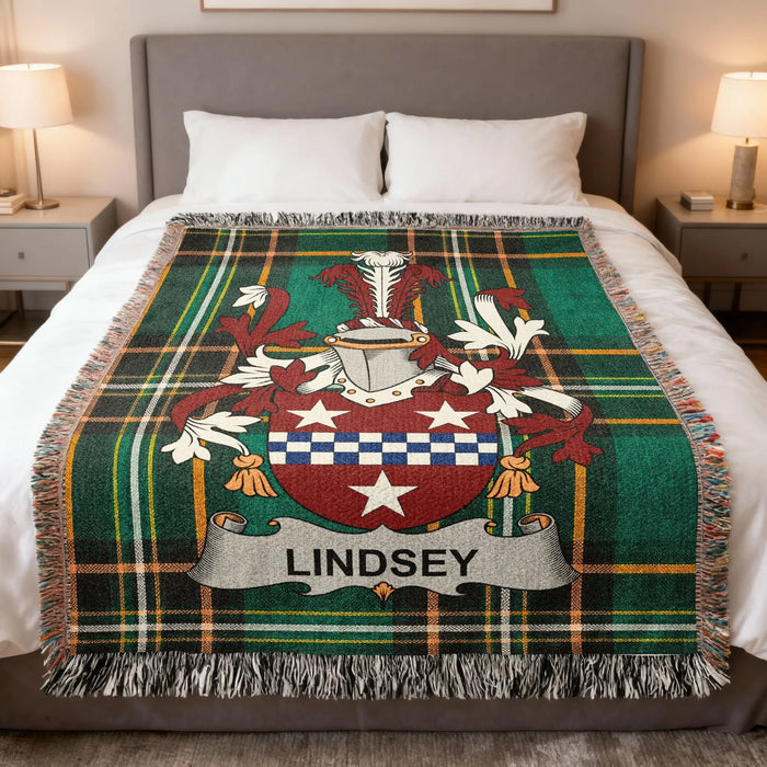Lindsey family crest woven blanket draped over a bed.