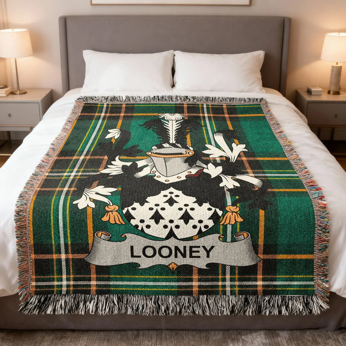 Green and black tartan blanket with a coat of arms and LOONEY name.
