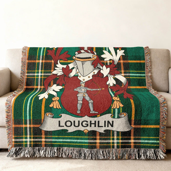 Green tartan throw blanket with a coat of arms featuring a knight and the name LOUGHLIN.