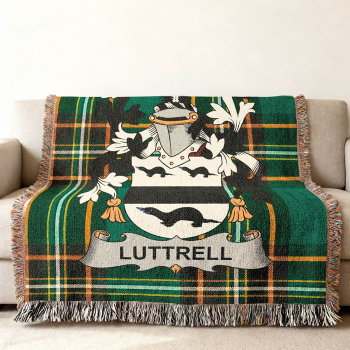 Luttrell family crest on a green and black plaid woven throw blanket.