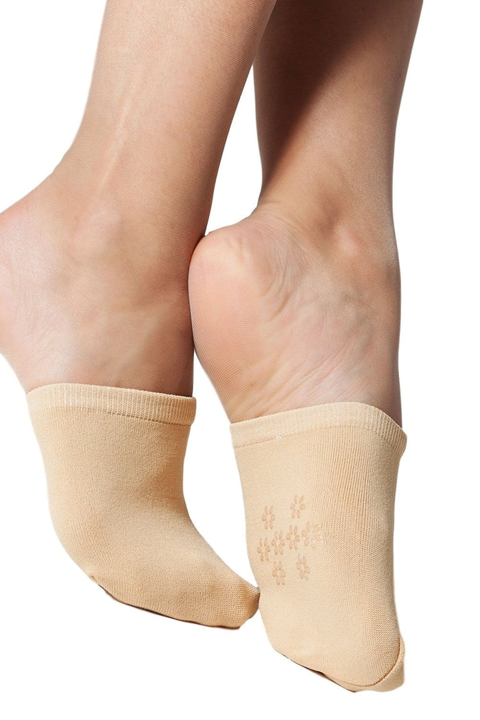 Natursl mule  socks worn on feet against a white background