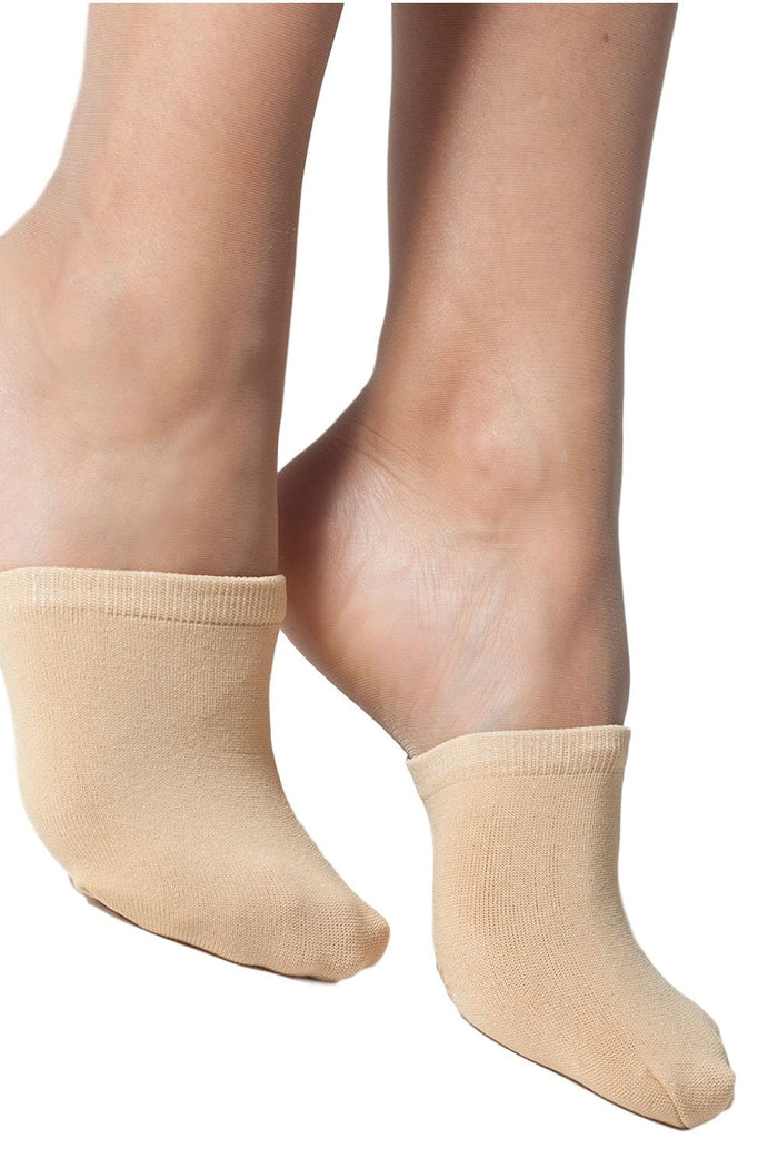 Natural mule socks  worn by a model on a white background