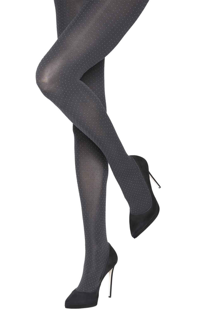Two tone spot tights worn with black high-heeled shoes on a white background