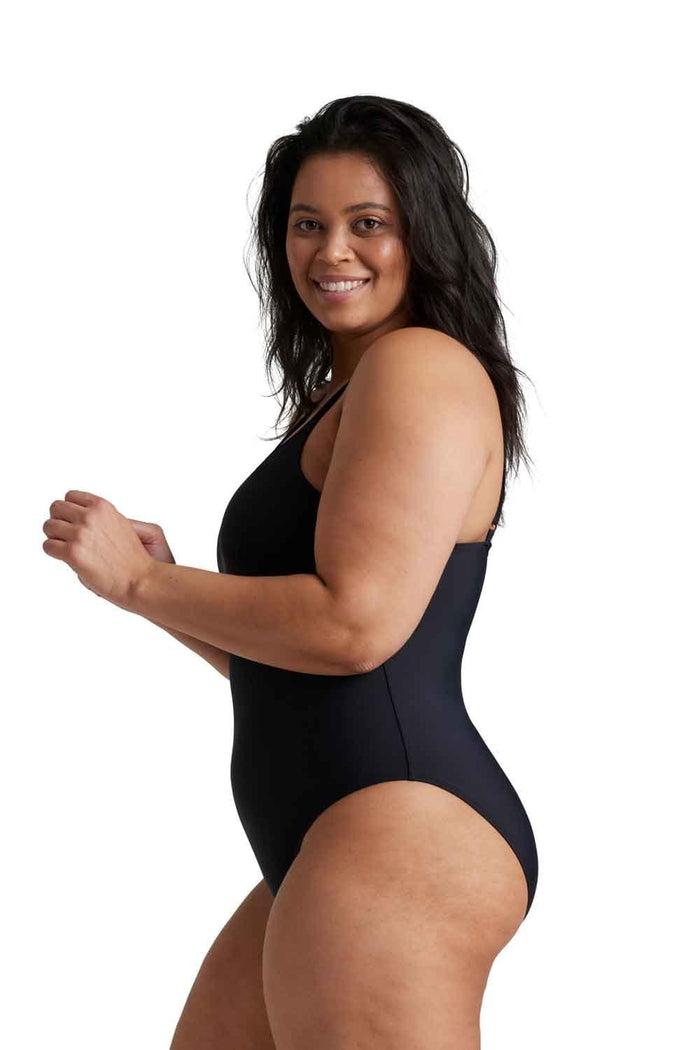 Woman wearing a black period one piece swimsuit on a white background