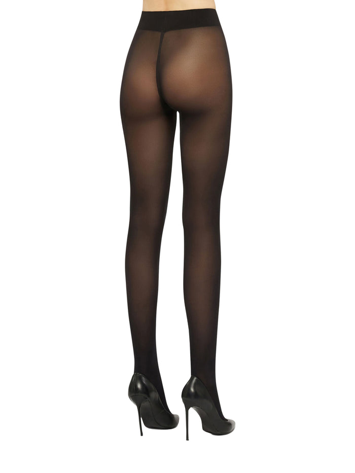 Black opaque tights worn by a model on a white background