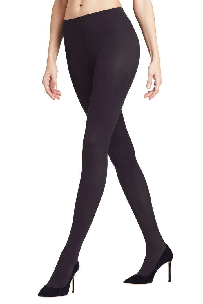 Black tights worn by a model on a white background