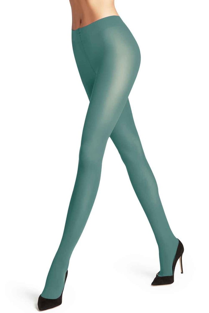 Falke Teal tights worn by a model on a white background