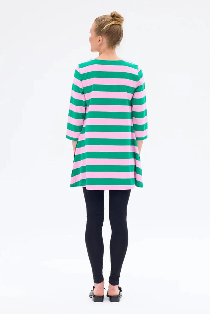 Person wearing a green and pink striped dress on a white background