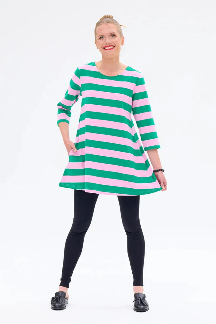 Woman wearing a green and pink striped dress on a white background