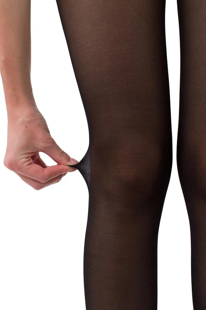 A close-up of a person's leg wearing sheer black tights, with a hand pulling the fabric slightly to show the stretch and transparency of the hosiery.