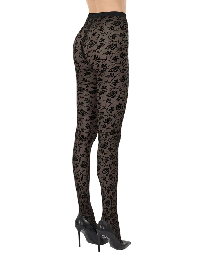 Black floral lace tights on a neutral background