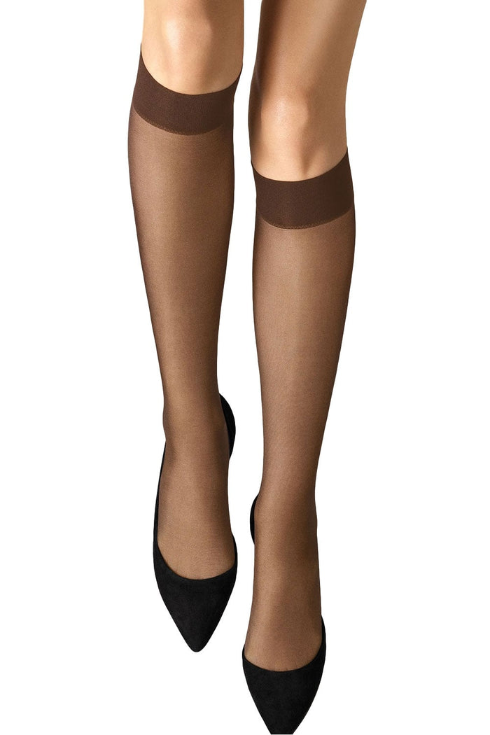 satin touch nearly black  knee highs worn with black high heels on a white background