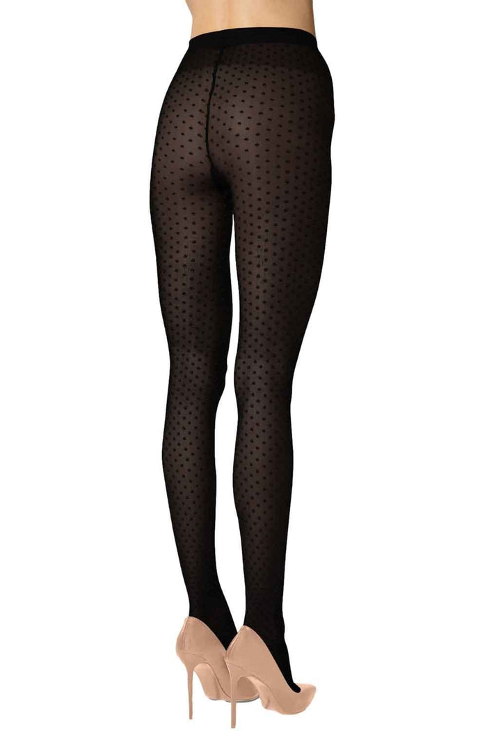 Black polka dot tights worn by a person on a white background