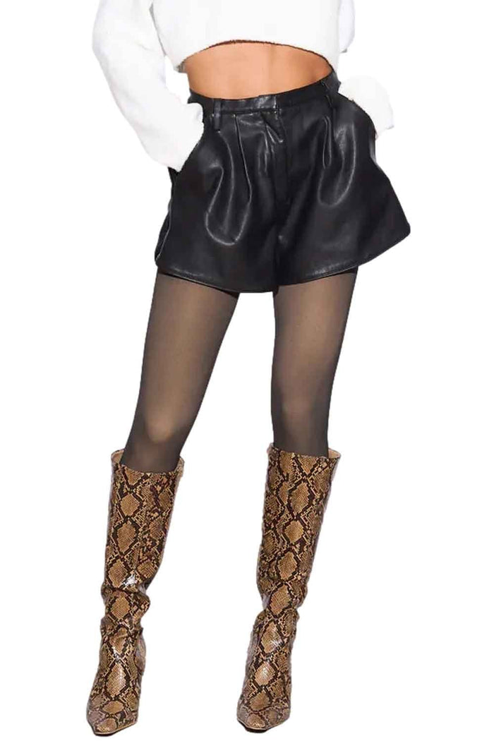 Model wearing black leather shorts with fleece lined tights  and snake print boots on a white background