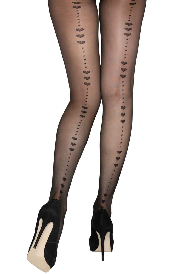Black tights with heart patterns on backseam worn by a person on a white background