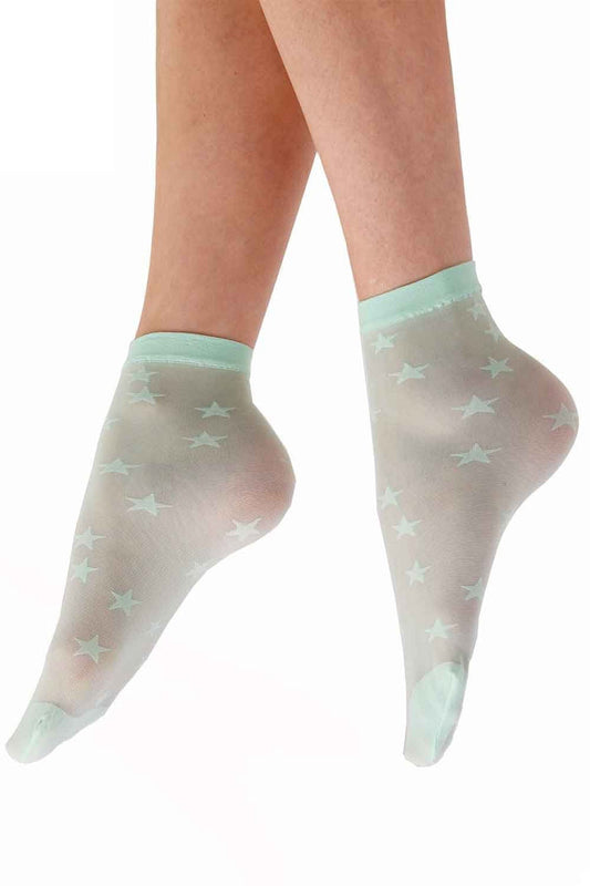 Sheer socks with star patterns worn by a person on a white background