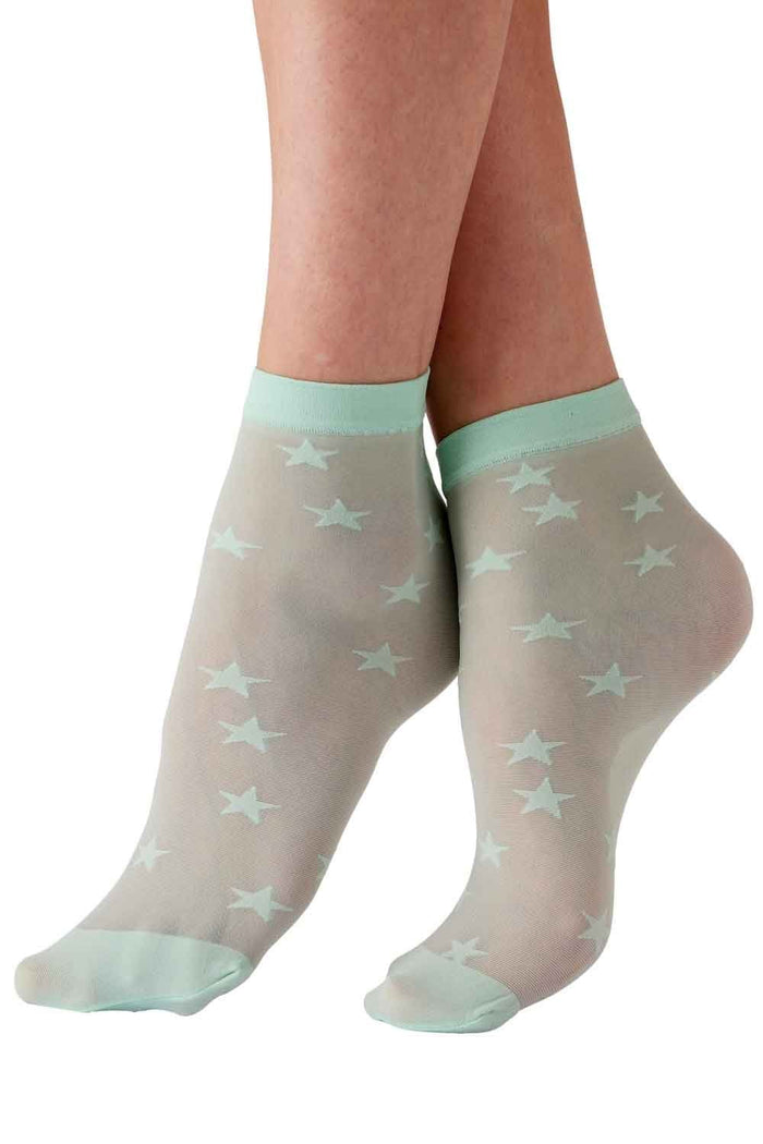 Sheer socks with star pattern and light green edges worn by a person on a white background