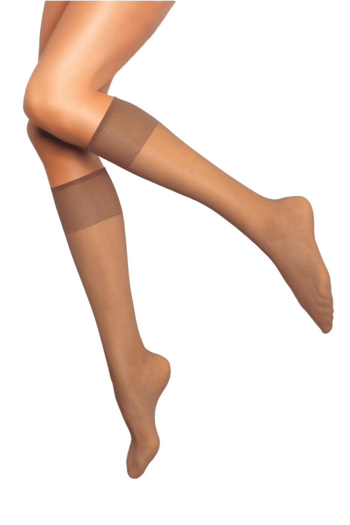 Nude knee highs worn by a person on a white background