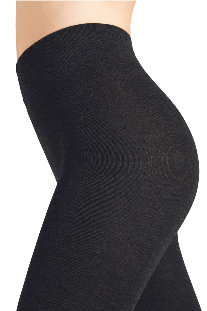 Black marino tights worn by a person on a white background
