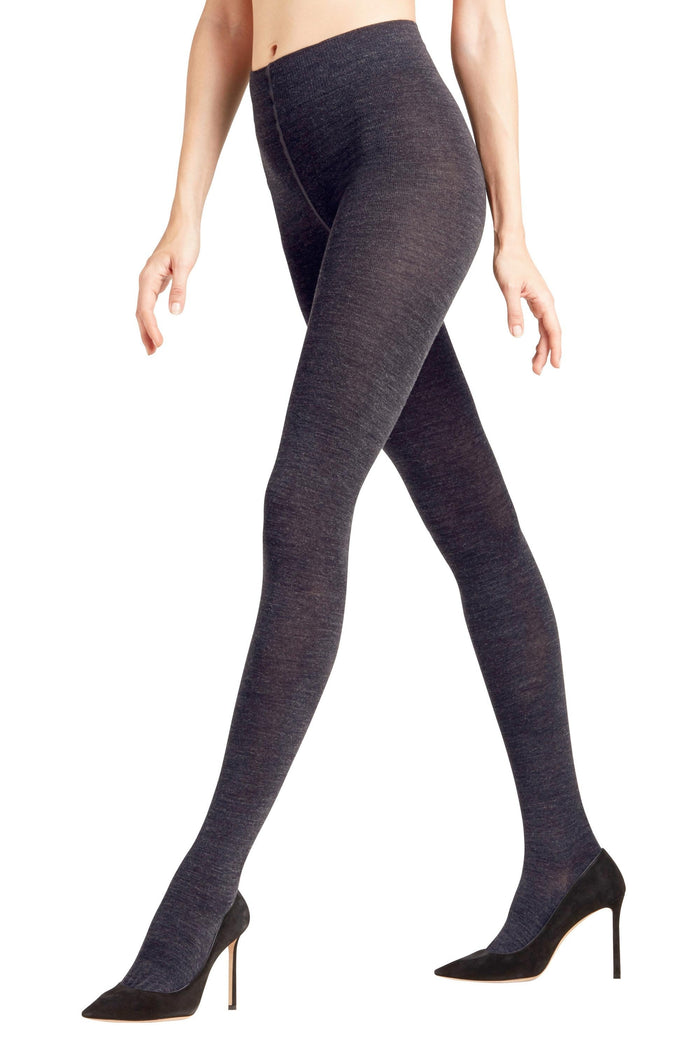 Dark navy marino wool tights worn by a person on a white background