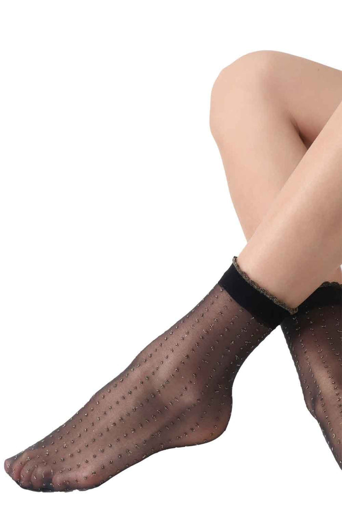 Black/gold socks worn by a person on a white background