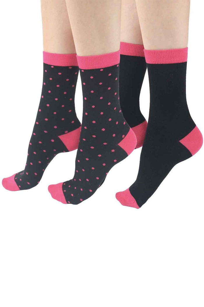 Black socks with pink accents and polka dot pattern on a white background