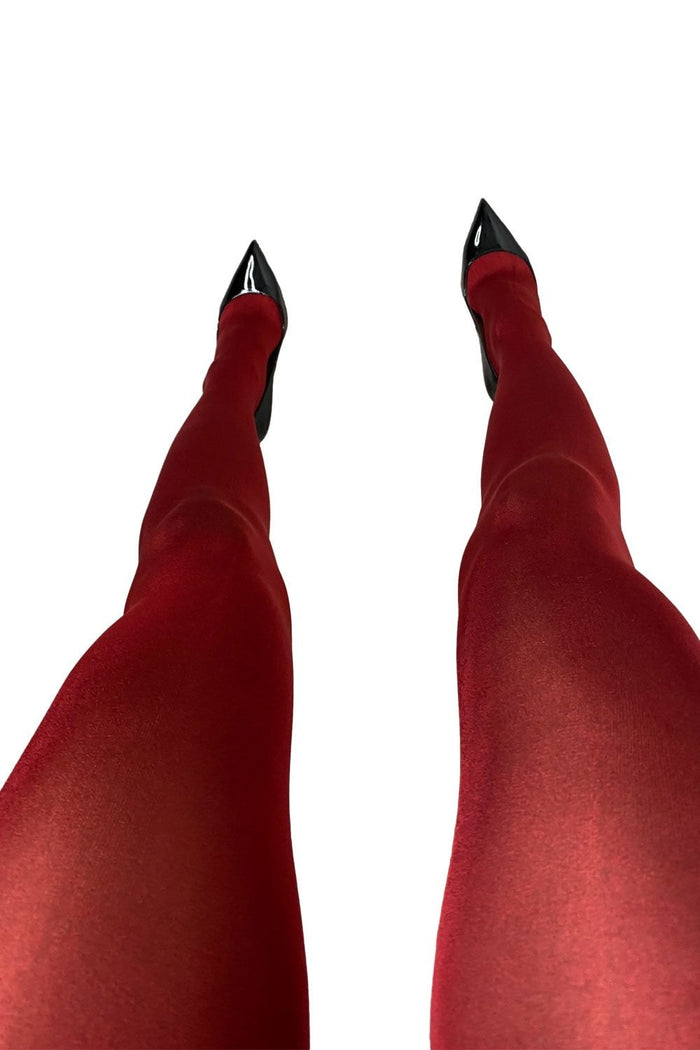 Bordaux tights worn with black high-heeled shoes on a white background