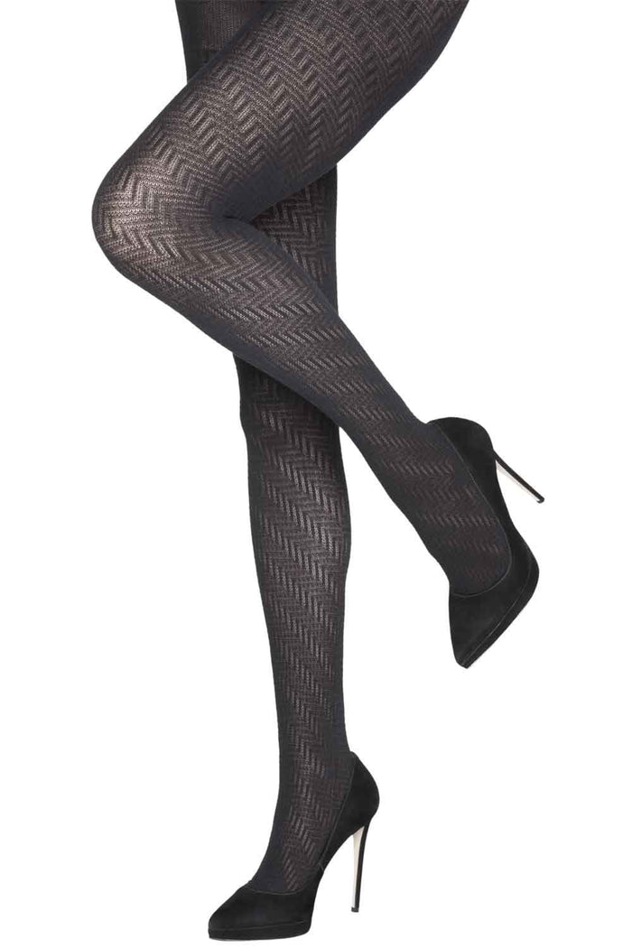 Black zig zag  patterned tights worn with black high-heeled shoes on a white background