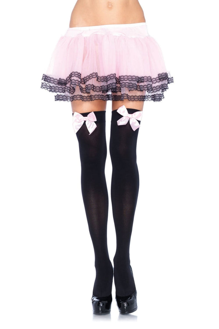 Black thigh high socks with pink bows  and a pink lace-trimmed skirt on a white background
