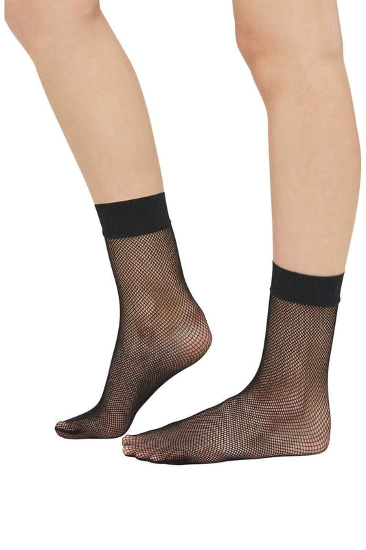 Black fishnet socks worn by a person on a white background