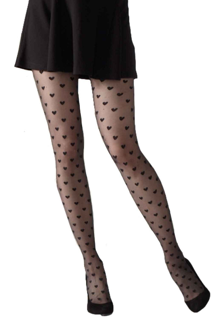 Sheer tights with heart pattern worn over a black skirt on a white background